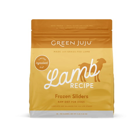 A package of Green Juju Lamb Recipe Frozen Sliders for dogs. The packaging is yellow with a graphic of a dog and text detailing the product as raw diet food made with grass-fed lamb.