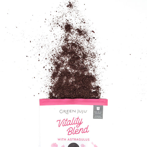Green Juju Vitality Blend packaging with the freeze-dried vegetable blend spilling out on a white background